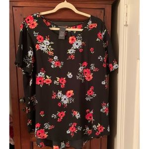 Floral 100% polyester short sleeve blouse. Longer in the back